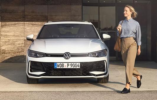 Frau im Business-Look läuft an einem geparkten Passat R-Line vorbei